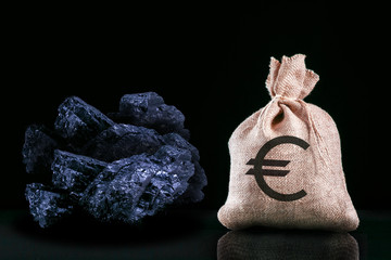 Bag with Euro banknotes and coal stones close up. Mining industry concept with euro and coal.