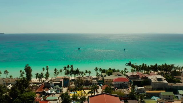 Tropical white sand beach with sailing yachts, hotels near the blue lagoon and corall reef. aerial view, Boracay, Philippines. Seascape with beach on tropical island. Summer and travel vacation