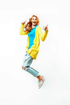 pretty young redhad teenage girl jumping happy smiling on white background, lifestyle people concept