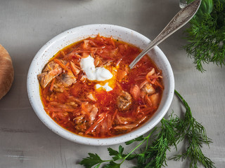 Red borsch with a tablespoon is shot at close range