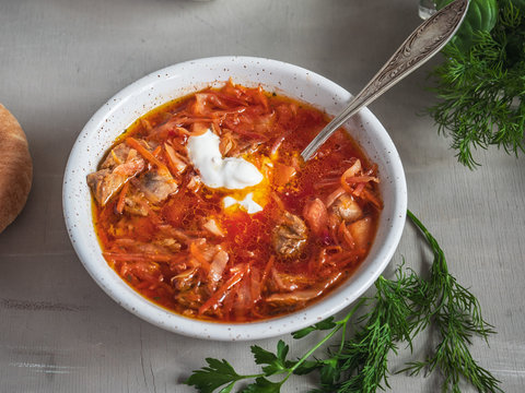 Red borsch with a tablespoon is shot at close range