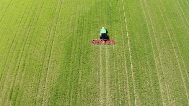 Aerial view of tractor cultivating field