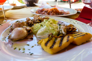 Mixed grilled seafood in Venezia, Italy with polenta