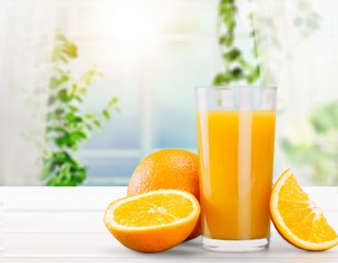 Orange juice and slices of orange on background