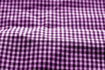 Checked fabric texture in blur effect in purple tone.