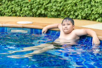 Obese boy relaxing enjoying hot tub bubble bath