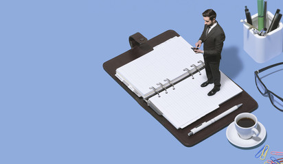 Corporate businessman stading on a open organizer
