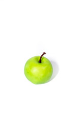 Artificial green apple on white background, clipping part closeup