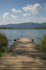 Wooden pathway and jetty in the lake.
