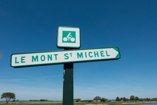 A Sign Shows The Cycle Route To Tourist Attraction Le Mont St Michel In France