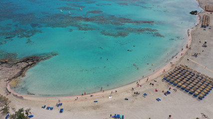 Aerial top view photo of men practising wind surfing in exotic paradise open ocean bay with crystal clear turquoise sea
