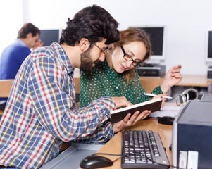 Couple of students studying in computer class