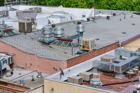 Air Conditioning Systems On Roof Of Commercial Buildings. The Rooftop Location Benefits From Less Noise Pollution, Minimize Dirt And Damage, Increased Security, Space Savings And Ease Of Maintenance