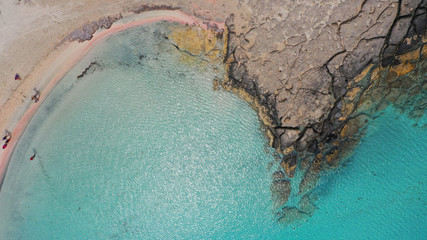 Aerial top view photo of men practising wind surfing in exotic paradise open ocean bay with crystal clear turquoise sea