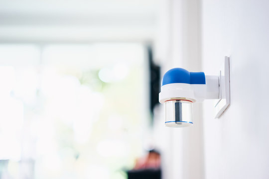 Mosquito killer. Electric raptor fumigator at outlet on the wall.