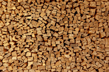 The texture of wooden firewood, randomly split and laid in straight rows