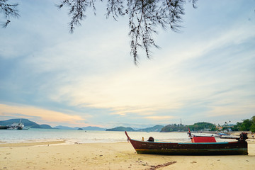 Fototapeta na wymiar Beautiful landscape with traditional longtail boat on the beach. Phuket, Thailand.