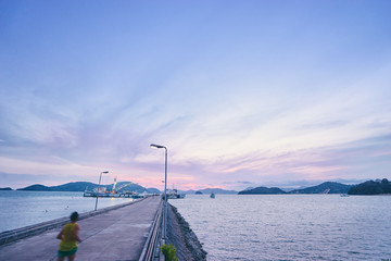 Sports lifestyle. Jogging outdoors. Man running on the sea pier. Motion blur.