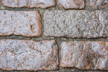 Wet cobblestone pavement.