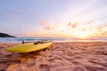 Beautiful landscape. Sunset on the sea beach with lifeguard surf board on sand.