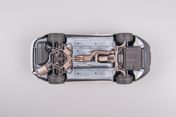 Upside down car on a gray background, upside down. The concept of service and repair.