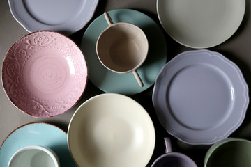 Collection of pottery and kitchenware in muted pastel colors. Top view.