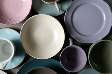 Collection of pottery and kitchenware in muted pastel colors. Top view.