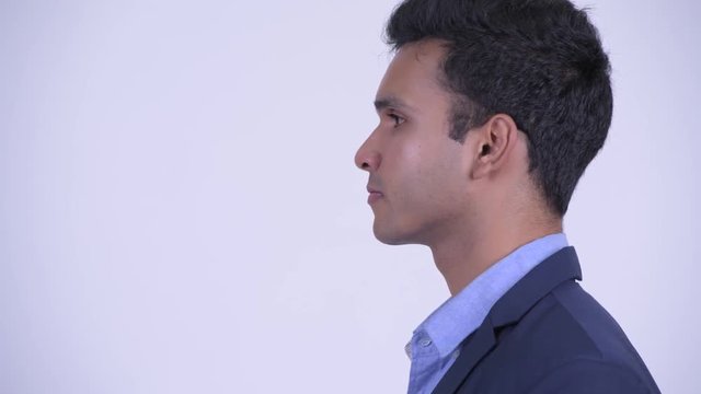 Closeup profile view of young Indian businessman in suit
