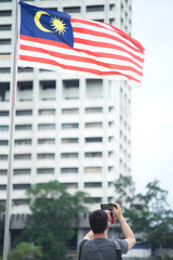 A tourist snap the photo Malaysia flag by his smartphone - 271467857