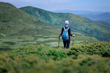 Active lifestyle. Traveling, hiking and trekking concept. Young woman with backpack in the Carpathian mountains.