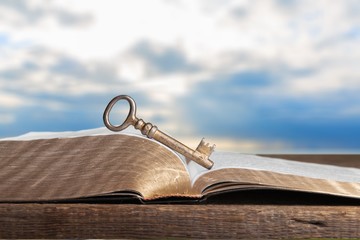 Open book on old wooden table.