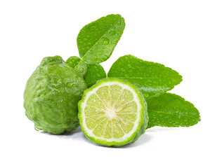 Fresh Bergamot fruits cut in half with leaves isolated on white background