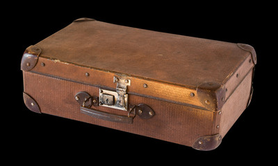 Old shabby vintage suitcase isolated on black background. Retro style