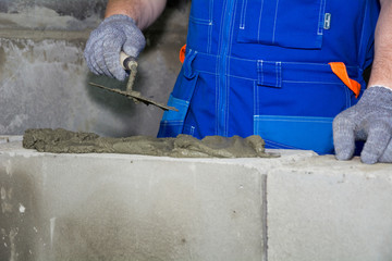 Building a building wall with cement. Concept of construction. Foam installation