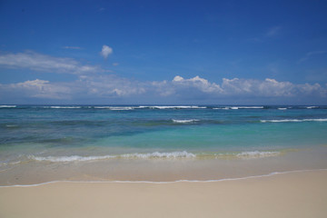 View from a beautiful white sandy beach on the ocean horizon and blue sky