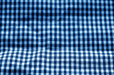 Checked fabric texture in blur effect in navy blue tone.