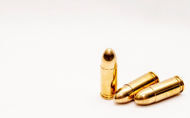Three full metal jacket 9mm bullets on a white background with room for text
