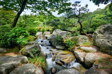 Beautiful small waterfall in japanese park.