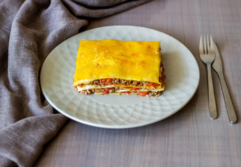 Lasagna on a gray background. Italian cuisine.