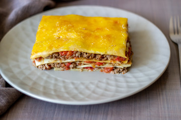 Lasagna on a gray background. Italian cuisine.