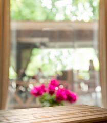 Empty of wood table top on blur of curtain with window view green from tree garden background.For...
