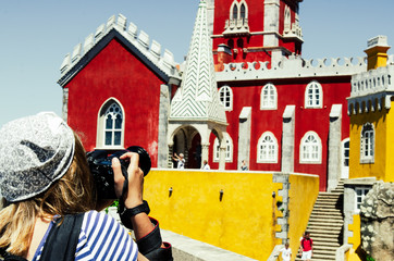 MAY 3 2016, SINTRA, PORTUGAL: young woman taking picture at beautiful view to Pena palace in Portugal