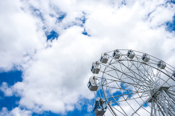 ferris wheel against the sky. Amusement park. Tourism.