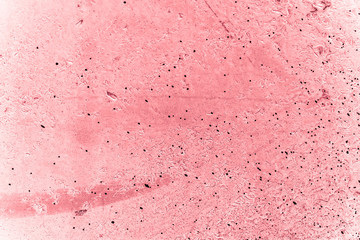 Vintage pink background. Rough painted wall of fiesta color. Imperfect plane of rosy colored. Uneven old decorative toned backdrop of rouge tint. Texture of pink hue. Ornamental stony surface.