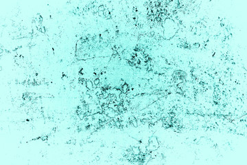Vintage azure background. Rough painted wall of turquoise color. Imperfect plane of cyan colored. Uneven old decorative toned backdrop of aqzure tint. Texture of teal hue. Ornamental stony surface.