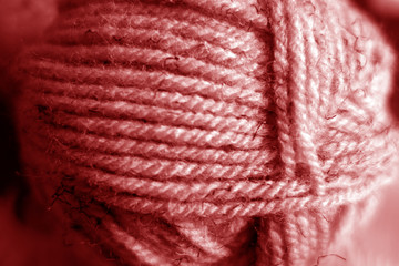 Yarn ball close-up with blur effect in red tone.