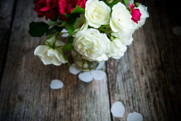 bouquet of beautiful red and white roses on a wooden