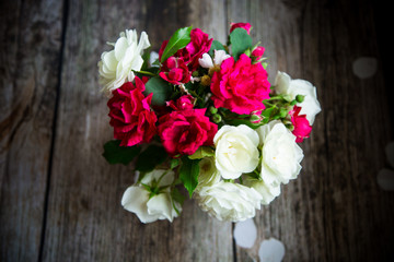 bouquet of beautiful red and white roses on a wooden