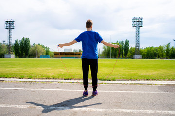 male athlete sportsman practice with jump rope at the outdoor stadiums, increase stamina