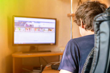 young man working with computer and typing on a keyboard at home, freelancer concepts